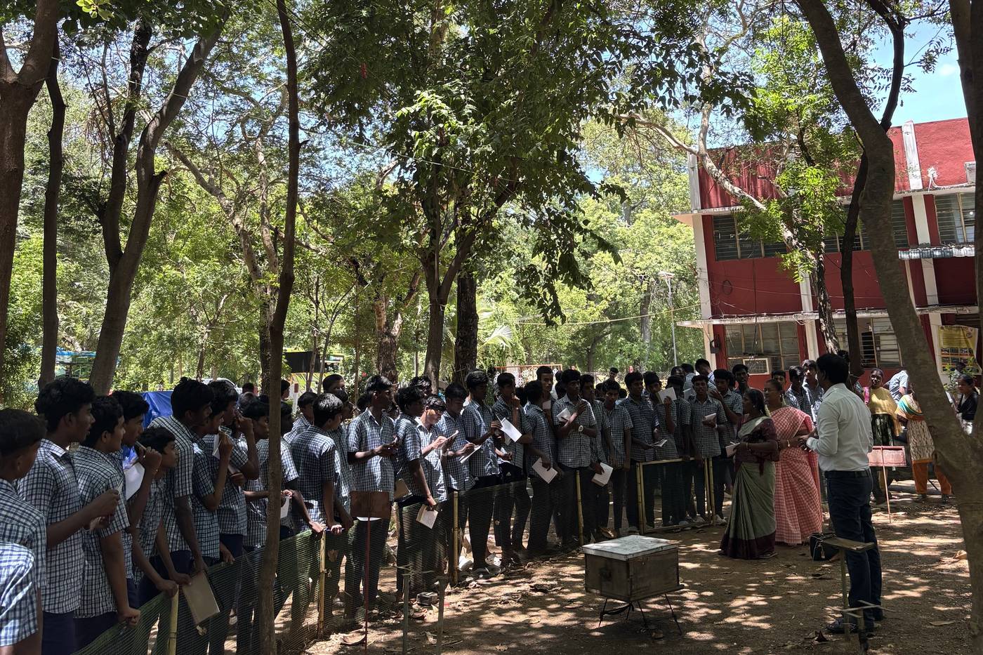 Students gathered under trees at an agricultural science exposure programme.