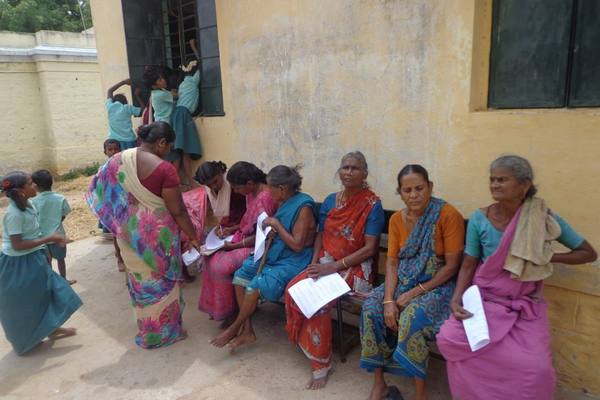 Elder women waiting their turn at a community registration session.