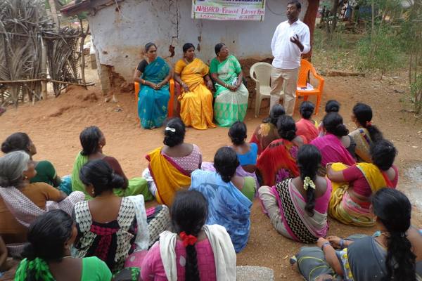 A self-help group meeting held in the hamlet, not the block town.